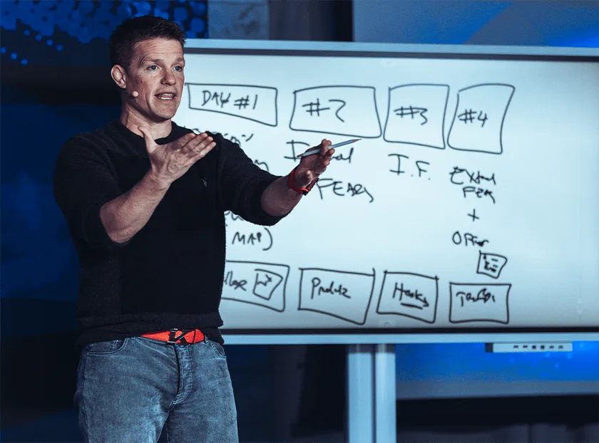 Russell Brunson mapping out the five day plan on a whiteboard